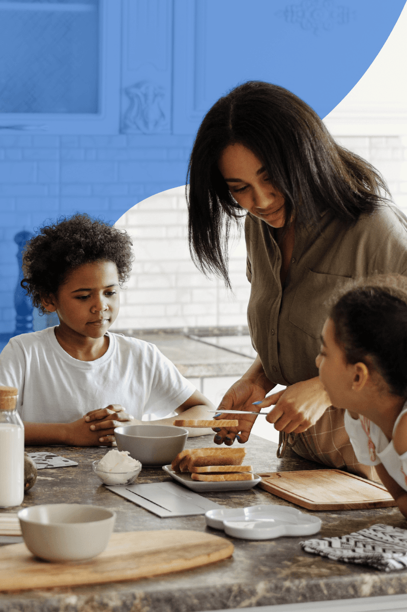 South African mother managing meal time alone with two young children at home
